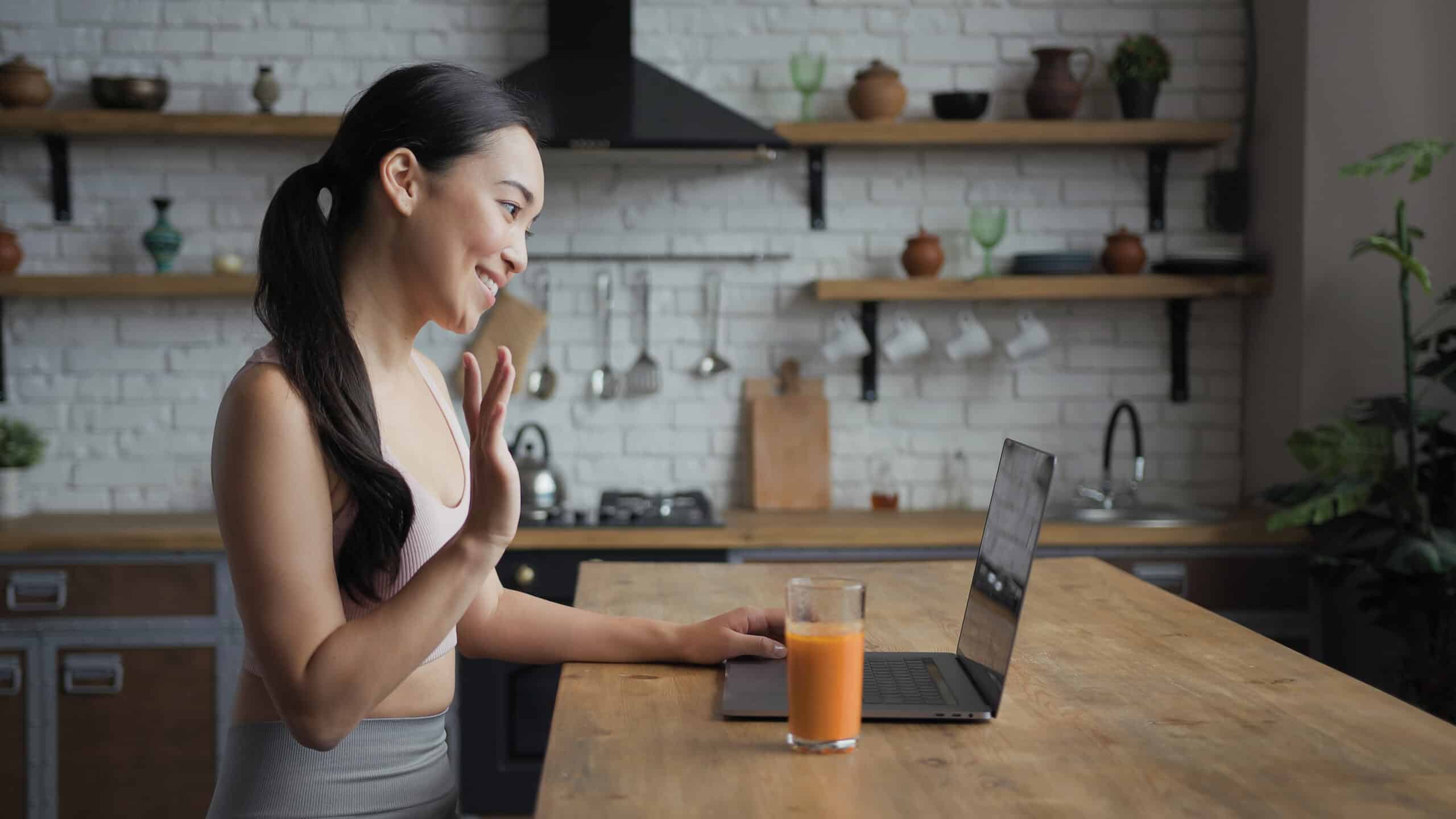 Healthy Asian Woman Talking On A Video Call On Laptop, Side View