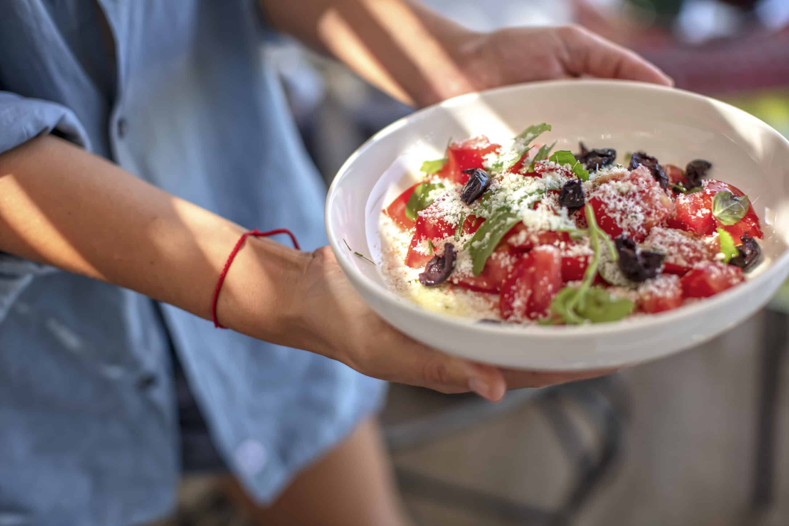 Young Woman Holding Parmesan Cheese, Tomato And Fresh Mint  Salad