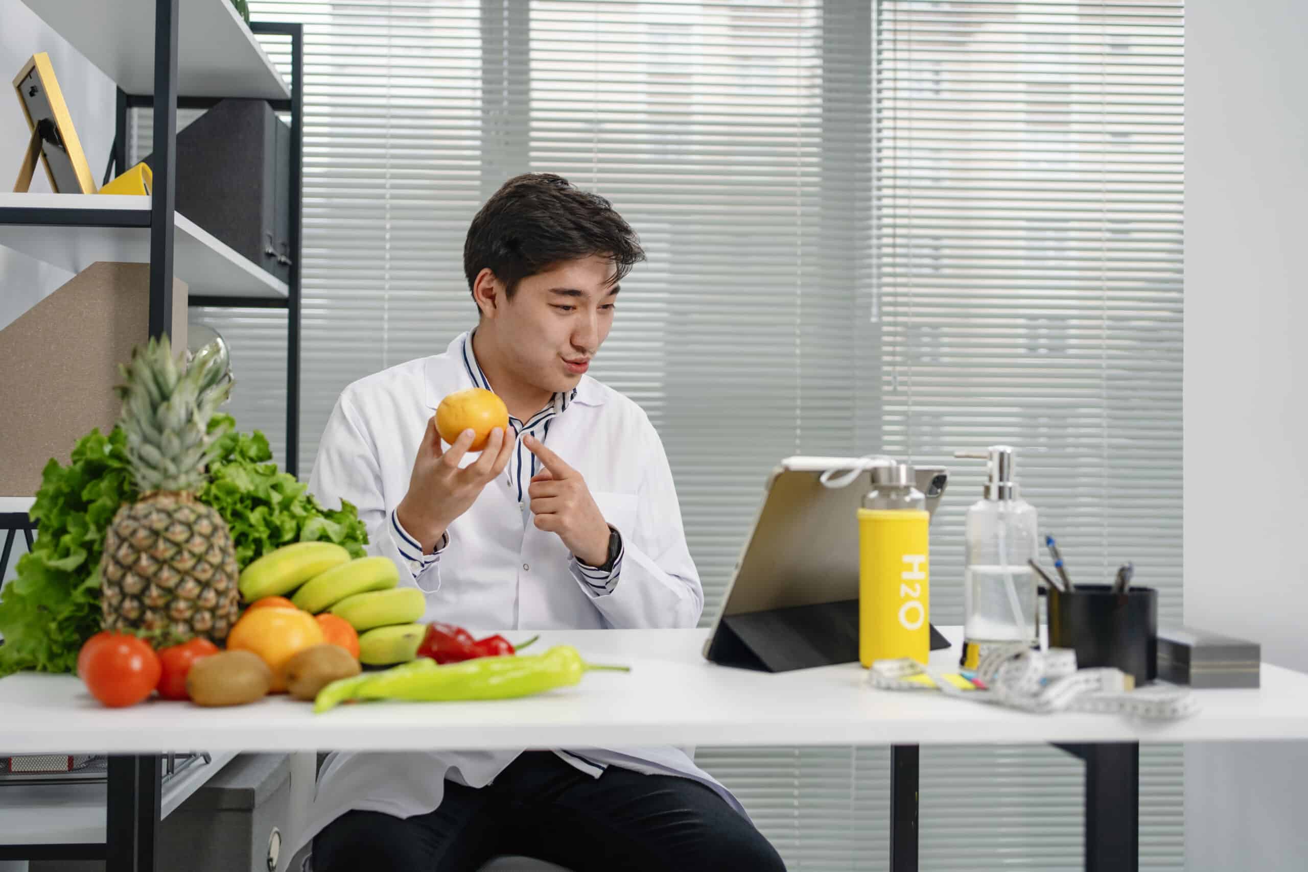 Nutritionist Uses A Digital Tablet To Conduct An Online Consultation With His Patient