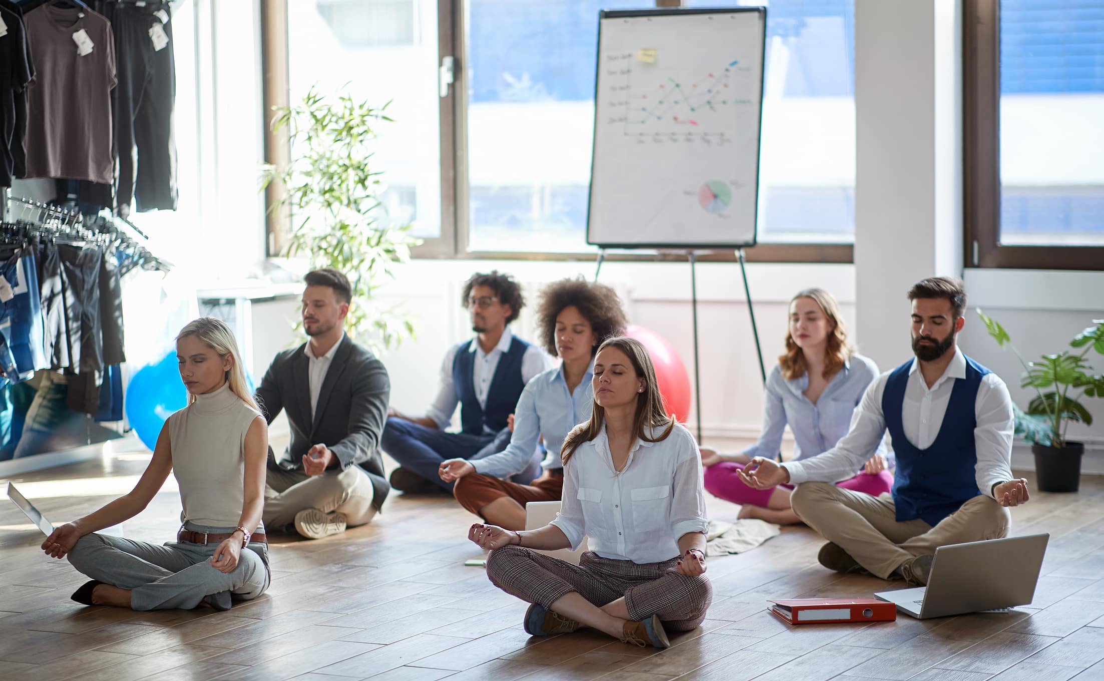 Group Of Business Colleagues Meditating At Work, Sitting On The Floor. Modern, Business, Meditation Concept