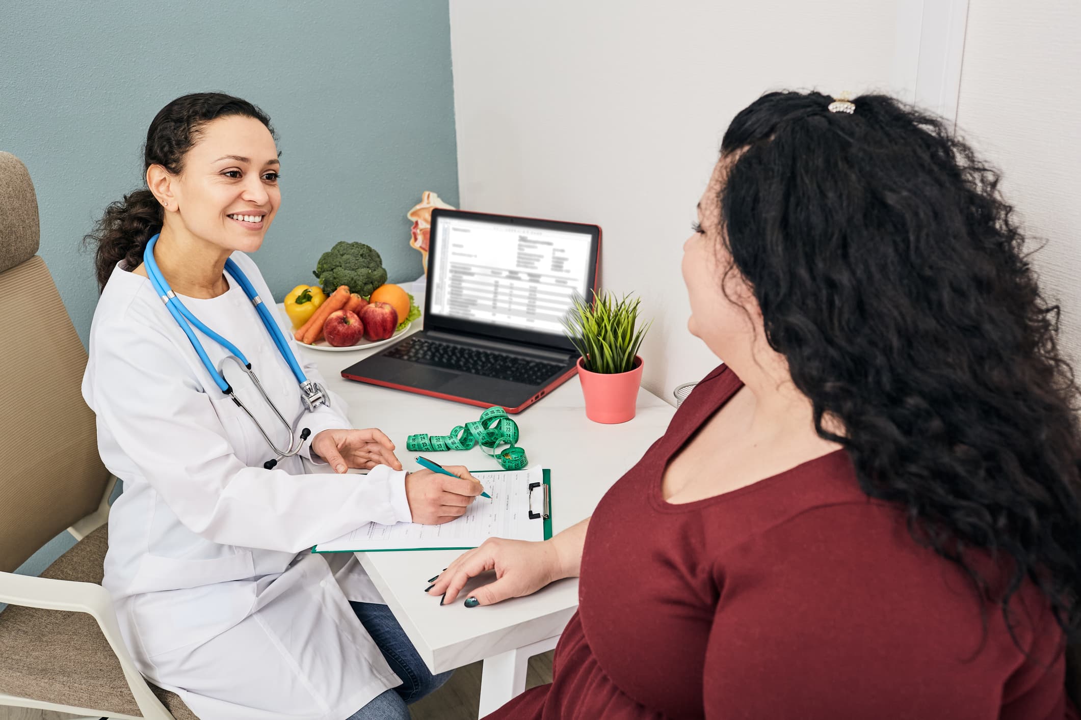 Nutritionist Consultation. Dietitian Plans Meal Plan For A Female Obese Patient
