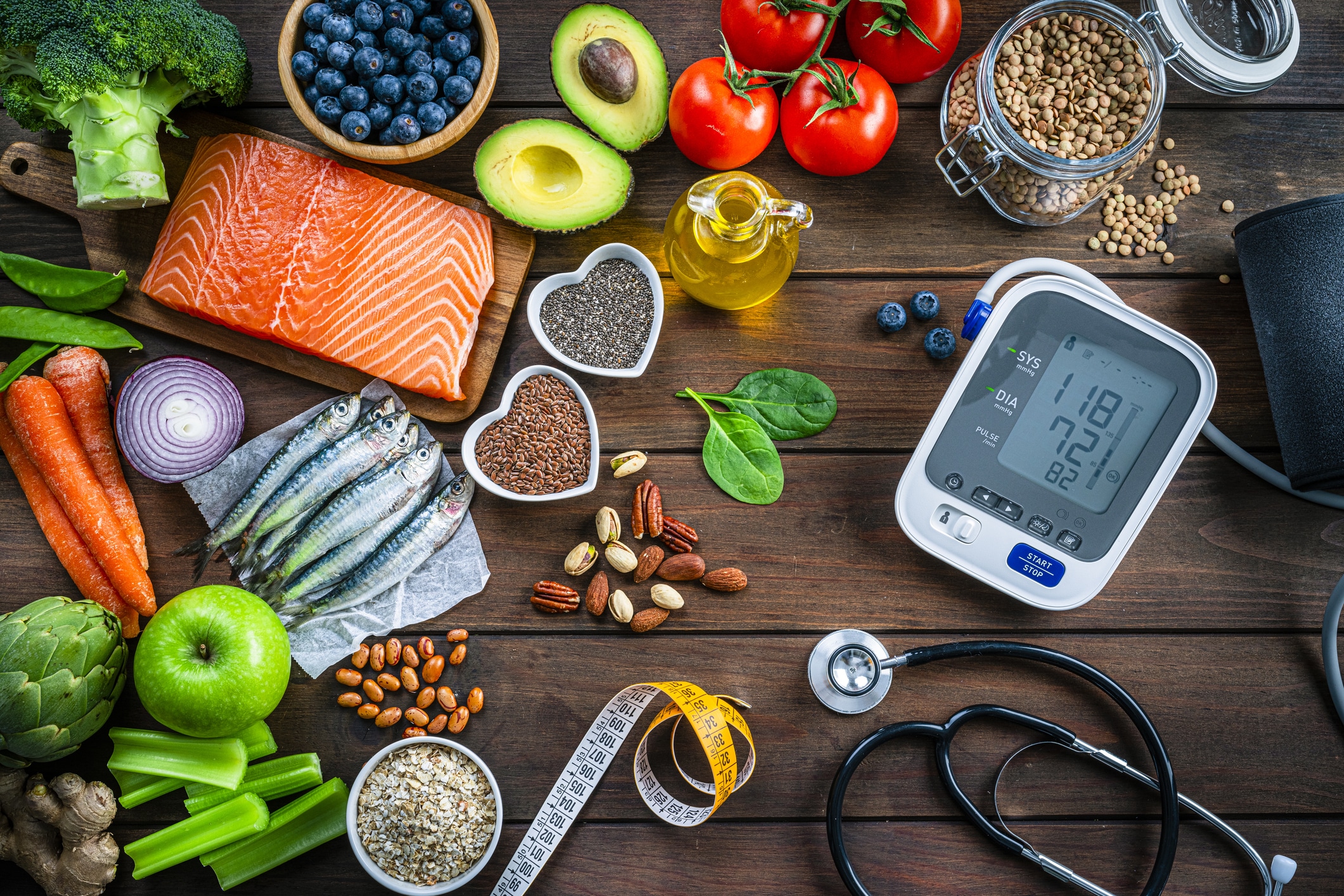 Dietitian For High Blood Pressure 1 Dietitian Group Healthy Food For Heart Care: Overhead View Of Healthy Food Rich In Omega-3 And Antioxidants And A Blood Pressure Monitor, Tape Measure And Stethoscope Shot On Wooden Table. The Composition Includes A Salmon Fillet, Sardines, Avocado, Extra Virgin Olive Oil, Brown Lentils, Celery, Artichoke Blueberries, Celery, Carrots, Brown Lentils, Asparagus, Artichoke, Broccoli, Flax Seeds, Chia Seeds And Some Nuts Like Almonds, Pistachio And Pecan. High Resolution 42Mp Studio Digital Capture Taken With Sony A7Rii And Zeiss Batis 40Mm F2.0 Cf Lens