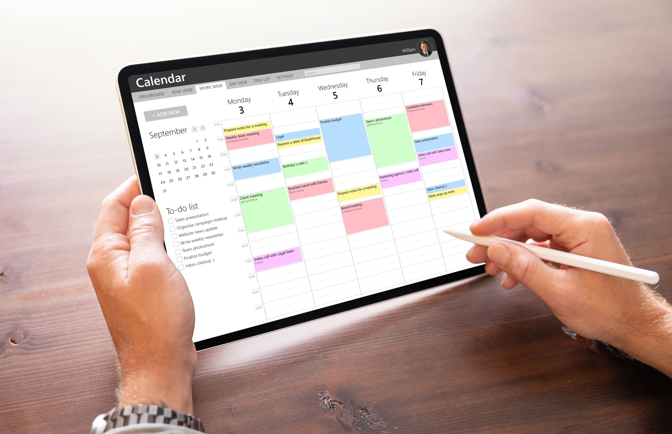 Man Using Calendar App On Tablet Computer