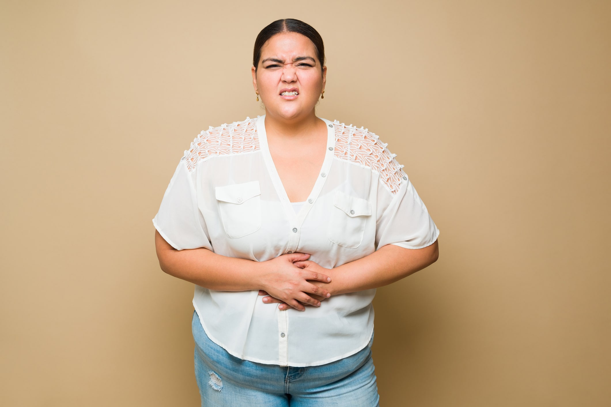 Sick Overweight Woman Touching Her Abdomen And Feeling Pain Because Of A Stomachache Or Cramps