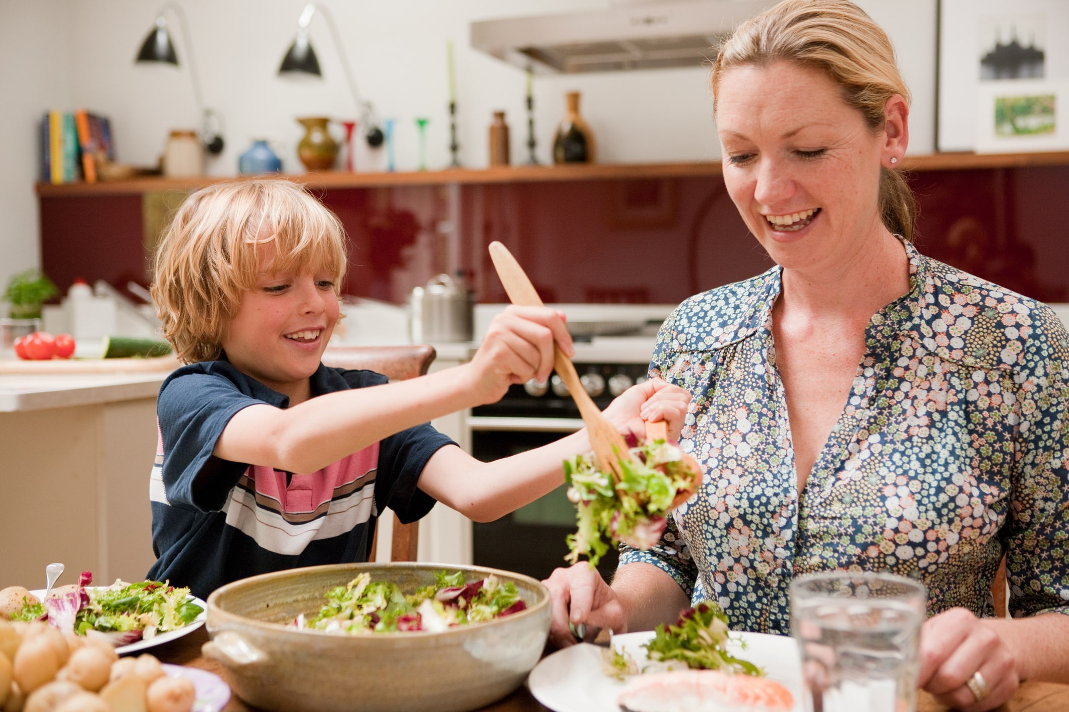 Weight Loss Dietitian 1 Dietitian Group Son Helping To Serve Salad For Mother At The Family Dinner Table