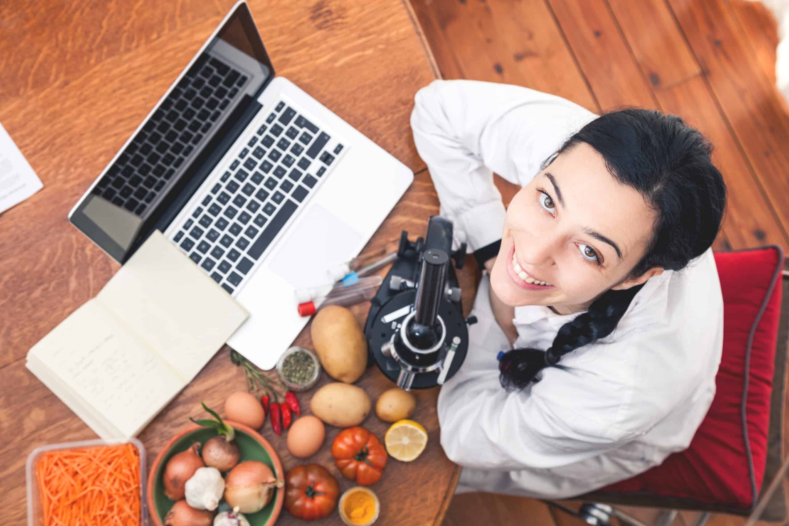 Nutritionist Setup Analyzing Food Using Microscope In Studio.