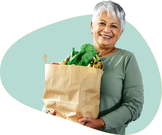 a senior lady with a bag of fresh vegetables and fruits