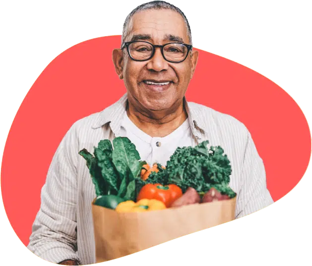 senior man with a bag of fresh vegetables and fruits