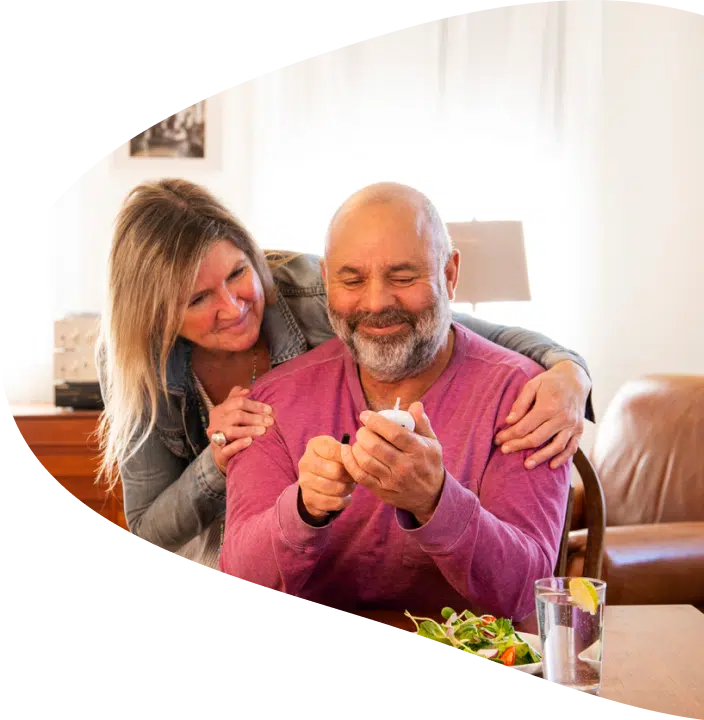 A couple smiling while looking at the diabetes test