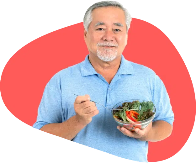 Senior Asian man holding a bowl of salad