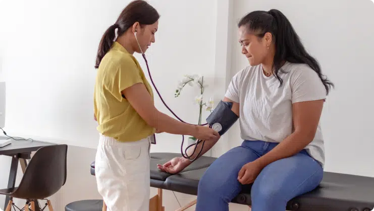 a lady in distress getting her blood pressure measured