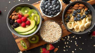 Bowls full of berries, fruits, and oats