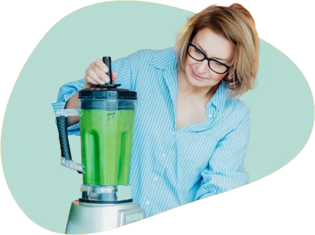 A woman making green juice