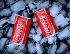 2 cola tins over ice