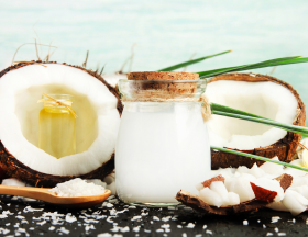 Coconut halves with a jar containing coconut water