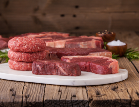 Raw steak and patties on the table