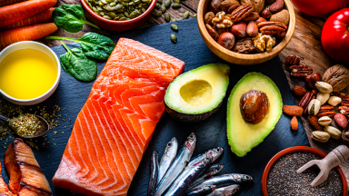 Fish, avocado, nuts and different vegetables on a table