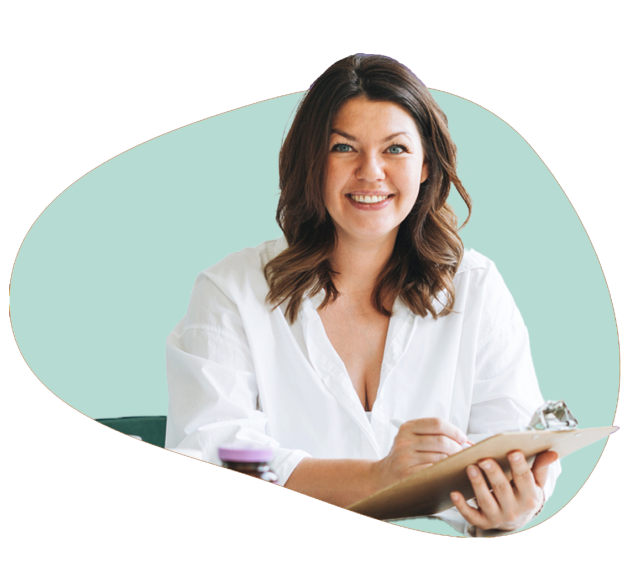 A smiling dietitian with paper and pen in hand