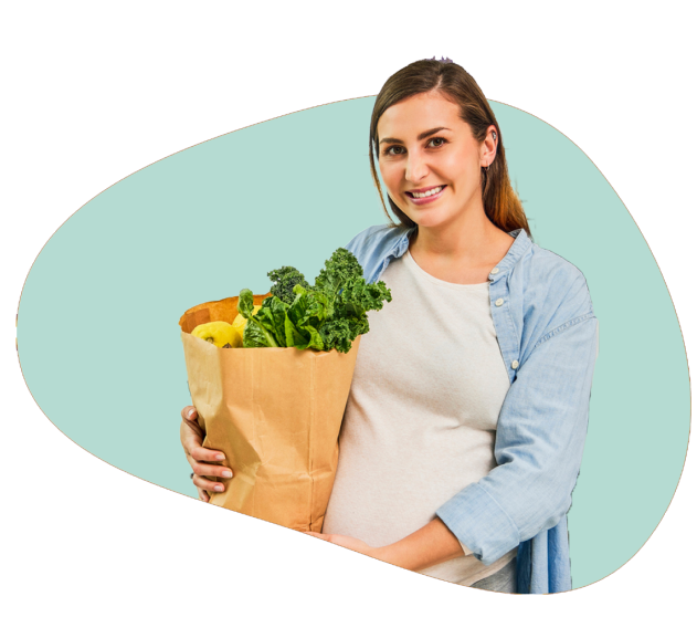 A pregnant lady with grocery bad full of vegetable