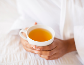 A woman holding a cup of tea