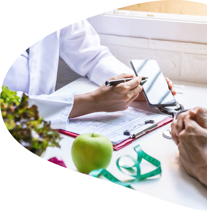 Dietitian holds a mobile device and pen, going over the shopping plan with their patient