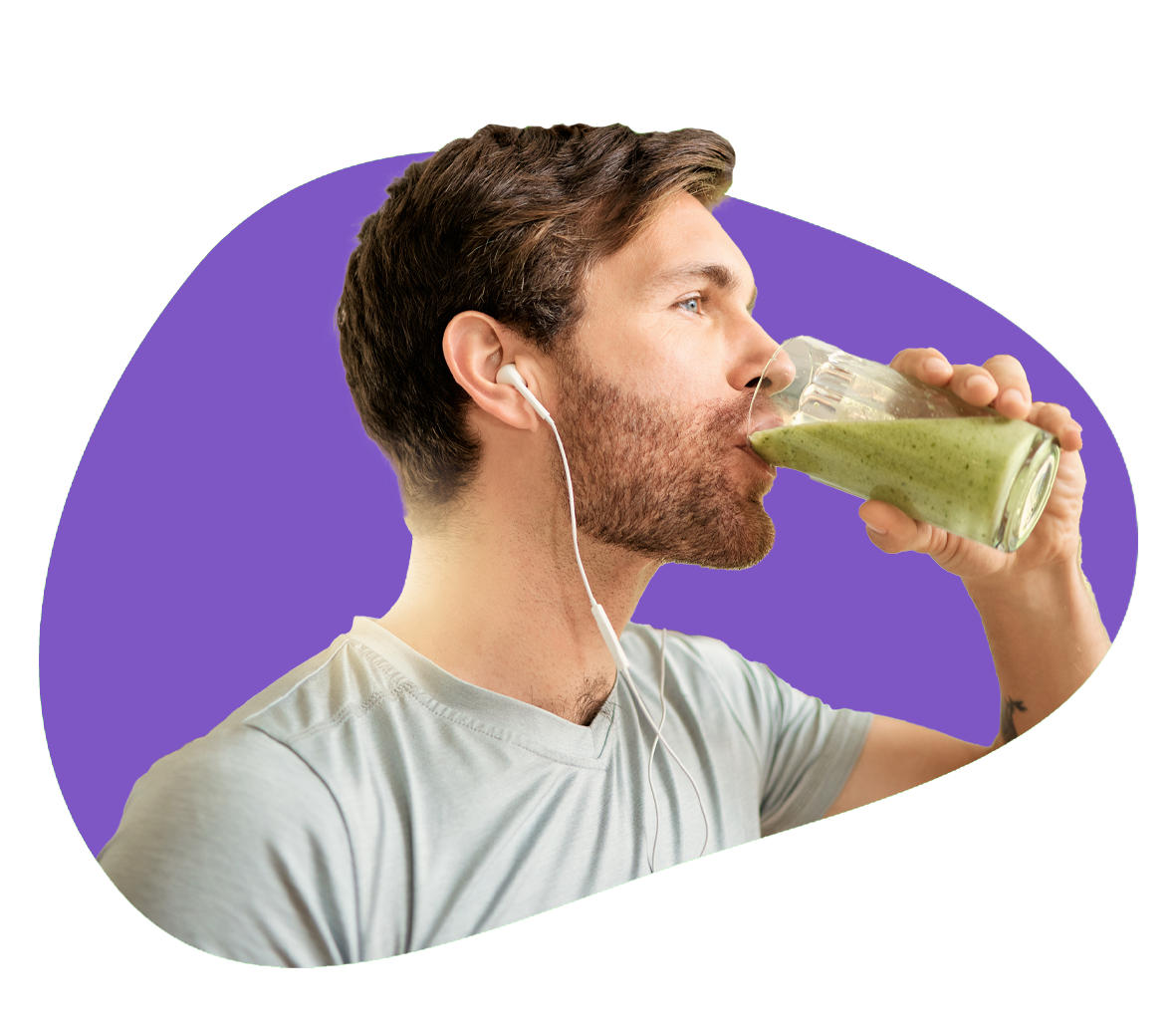 A person wearing earbuds stands and drinks a green drink to help with their sports nutrition.