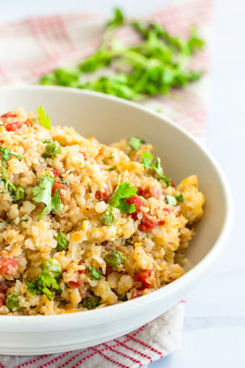 Cauliflower Rice Vertical Photo. Low Carb Cauliflower Stir-Fried Rice in a Bowl.