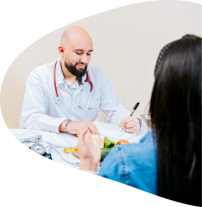 Dietitian works with patient, taking notes as they talk