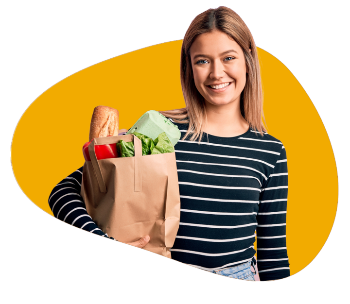 Person holds a shopping bag of groceries