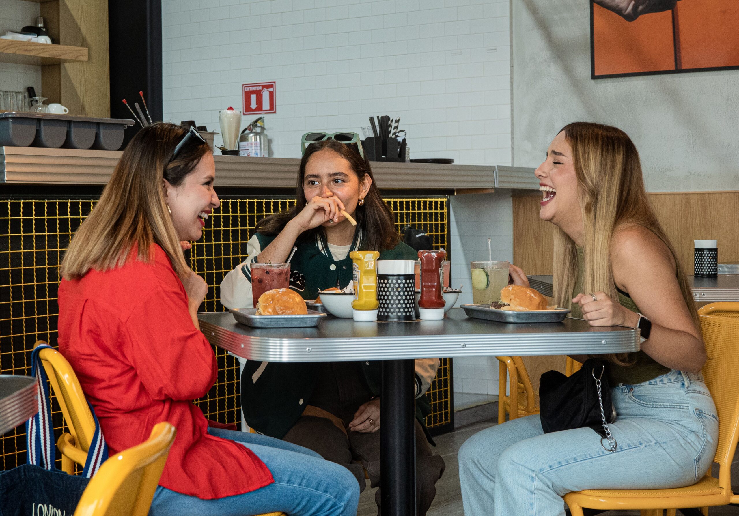 Friends Enjoying Food And Laughter Together.