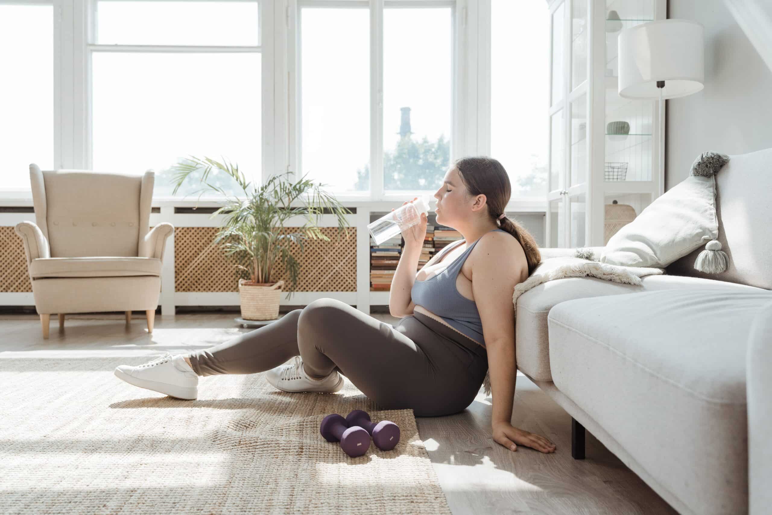 Woman On Glp-1 Drinking Water In Bright Room.