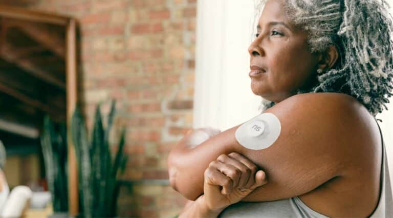 Woman With Glucose Monitor On Arm