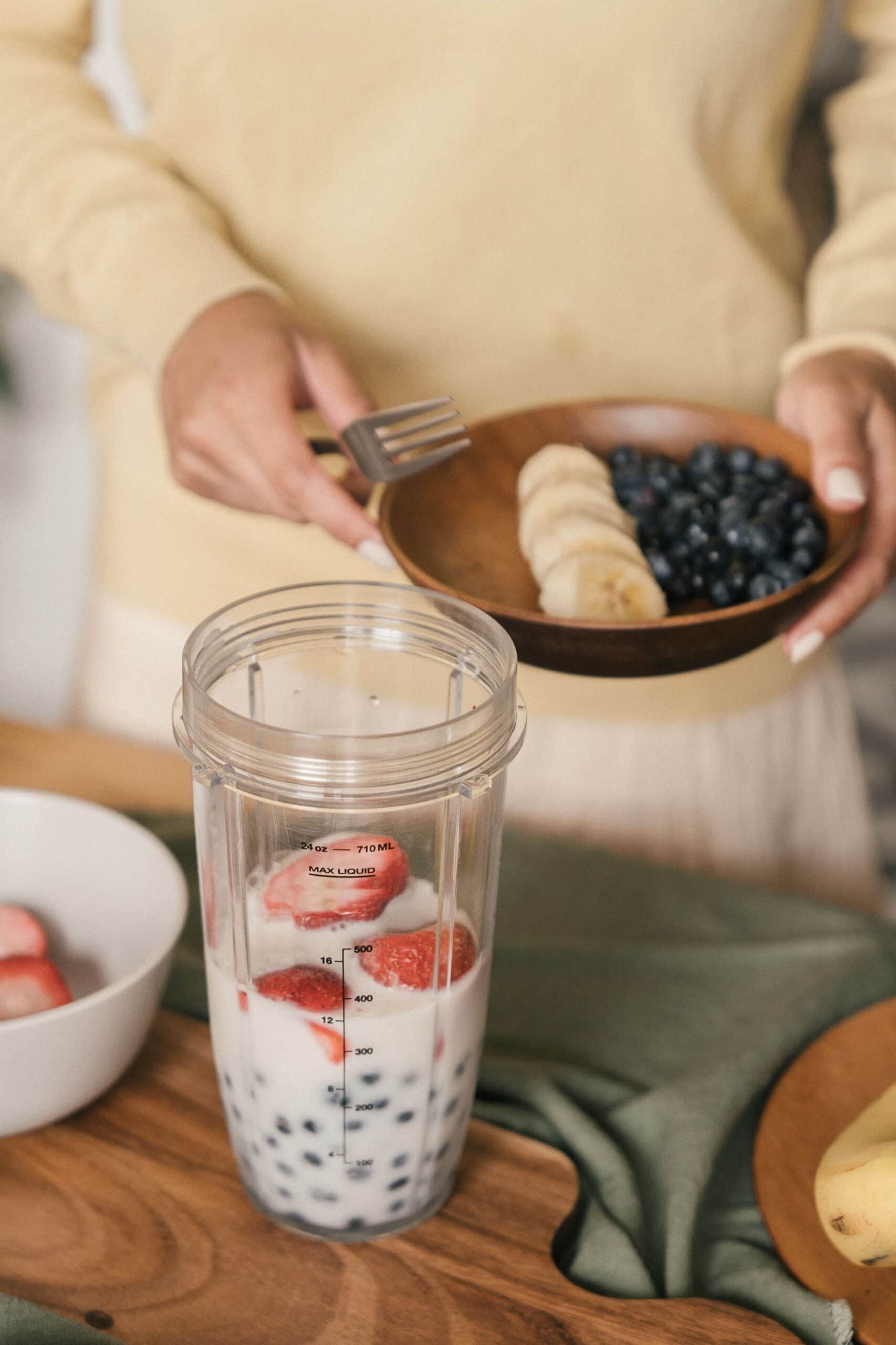 Homemade Protein Shake For Glp-1 Users With Milk, Strawberries, Blueberries, And Banana In A Blender Cup